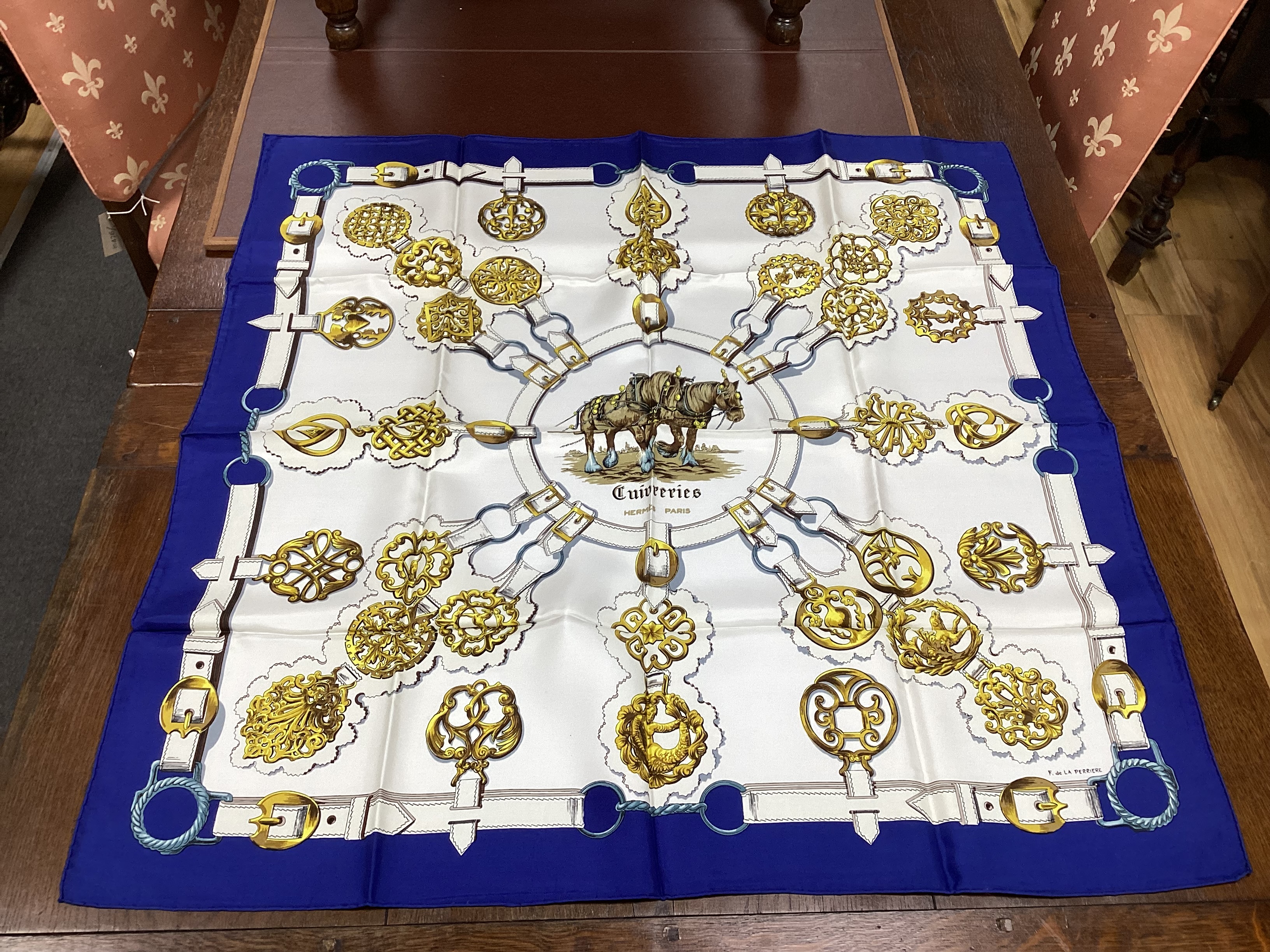 Four vintage Hermes silk scarves comprising Cosmos, Bride de Cour, Roues de Canon and a Cuivreries example retailed by Harrods